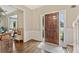 Welcoming foyer features hardwood floors, a wooden front door, and elegant wainscoting at 2904 Masonwood Nw Dr, Kennesaw, GA 30152