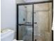 Modern bathroom features a tiled shower with glass door and convenient grab bars at 4347 Lanier Ridge Walk # 1501, Cumming, GA 30041