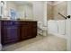 Bathroom featuring roll-in shower, dark wood cabinet and granite countertop at 4347 Lanier Ridge Walk # 1501, Cumming, GA 30041
