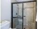 Shower with tile surround, glass door, and built-in seat at 4347 Lanier Ridge Walk # 1501, Cumming, GA 30041