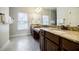 Bathroom featuring double sinks with granite countertop and tile floors at 4347 Lanier Ridge Walk # 1501, Cumming, GA 30041