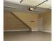 A clean garage with epoxy floors, overhead lighting, and built in shelving at 4347 Lanier Ridge Walk # 1501, Cumming, GA 30041