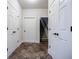 Hallway with multiple white doors and dark hardware, and a glimpse of stairs at 4347 Lanier Ridge Walk # 1501, Cumming, GA 30041