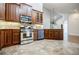 Kitchen with stainless steel appliances, granite countertops, and wood cabinets at 4347 Lanier Ridge Walk # 1501, Cumming, GA 30041