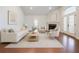Bright, staged living room with hardwood floors, neutral furniture, and fireplace at 4347 Lanier Ridge Walk # 1501, Cumming, GA 30041
