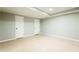 Large basement area with white doors, neutral walls, and comfortable carpeting at 4497 Windsor Oaks Dr, Marietta, GA 30066