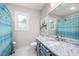 Lovely bathroom featuring granite countertop, a white sink, and bright blue shower curtain at 4497 Windsor Oaks Dr, Marietta, GA 30066