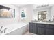 Bright bathroom features a soaking tub, granite countertop, and decorative artwork at 4497 Windsor Oaks Dr, Marietta, GA 30066