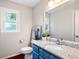 Stylish bathroom featuring blue vanity, granite countertop, mirror and natural light at 4497 Windsor Oaks Dr, Marietta, GA 30066