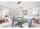 Bright dining room with a modern glass table, stylish chairs, and elegant light fixture at 4497 Windsor Oaks Dr, Marietta, GA 30066