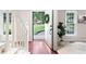 Bright foyer with hardwood floors, white staircase, and a view of the landscaped front yard at 4497 Windsor Oaks Dr, Marietta, GA 30066