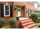 Close-up of the brick entryway, decorative plants, and a classic white front door with wreath at 4497 Windsor Oaks Dr, Marietta, GA 30066