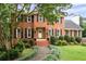 Beautiful two-story brick home with black shutters, a manicured lawn, and a welcoming front entrance at 4497 Windsor Oaks Dr, Marietta, GA 30066