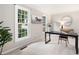 Stylish home office featuring neutral walls, a large window, and modern decor with a comfortable workspace at 4497 Windsor Oaks Dr, Marietta, GA 30066