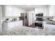 Open kitchen with granite countertops, stainless steel appliances, and a modern design at 4497 Windsor Oaks Dr, Marietta, GA 30066
