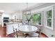 Eat-in kitchen with a dining table, modern chandelier, and a view of the backyard at 4497 Windsor Oaks Dr, Marietta, GA 30066