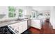 Bright kitchen featuring granite countertops, white cabinetry, stainless steel appliances, and hardwood floors at 4497 Windsor Oaks Dr, Marietta, GA 30066