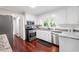 Clean kitchen with white cabinets, granite countertops, stainless steel appliances, and hardwood floors at 4497 Windsor Oaks Dr, Marietta, GA 30066