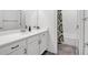 Bright bathroom featuring a vanity with a white countertop, cabinet storage, and a shower with stylish curtain at 1099 Heyward Way, Alpharetta, GA 30009