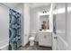 Modern bathroom features a vanity, toilet, and shower-tub with stylish blue patterned shower curtain at 1099 Heyward Way, Alpharetta, GA 30009