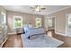 Spacious bedroom with hardwood floors, a ceiling fan, and natural light from the windows at 1099 Heyward Way, Alpharetta, GA 30009