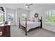 Bright bedroom with a four-poster bed, shuttered windows, and neutral decor for a serene retreat at 1099 Heyward Way, Alpharetta, GA 30009