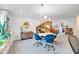 Inviting bonus room featuring a chandelier, and a view into another living area with a brick accent wall at 1099 Heyward Way, Alpharetta, GA 30009