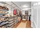 Walk-in closet featuring custom shelving and storage solutions for organizing clothing and accessories at 1099 Heyward Way, Alpharetta, GA 30009