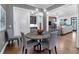 Cozy dining room with hardwood floors, a round wooden table, and views into the living room at 1099 Heyward Way, Alpharetta, GA 30009