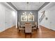 Formal dining room with chandelier, hardwood floors, grey walls, and decorative wall art at 1099 Heyward Way, Alpharetta, GA 30009