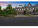 Well-manicured townhome with stone facade, two-car garage, and lush greenery in a tranquil setting at 1099 Heyward Way, Alpharetta, GA 30009