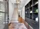 Welcoming foyer with staircase, hardwood floors, decorative rug, and black accent furniture at 1099 Heyward Way, Alpharetta, GA 30009
