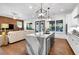 Modern kitchen with waterfall island, stainless appliances, hardwood floors, and open to the living room at 1099 Heyward Way, Alpharetta, GA 30009