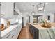 Open kitchen with white cabinets, hardwood floors, stainless appliances, and large kitchen island at 1099 Heyward Way, Alpharetta, GA 30009