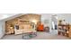 Comfortable living room with brick accent wall, stylish furniture, and views to bonus space with office/study area at 1099 Heyward Way, Alpharetta, GA 30009