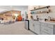Entertaining area with wet bar, sink, shelving, and living space at 1099 Heyward Way, Alpharetta, GA 30009