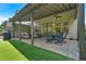 Lovely covered patio with comfortable seating, outdoor dining, and synthetic turf offers a great space for outdoor living at 1099 Heyward Way, Alpharetta, GA 30009