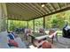 Inviting covered patio features comfortable seating, an outdoor dining area, and a built-in grill perfect for entertaining at 1099 Heyward Way, Alpharetta, GA 30009
