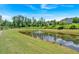 Community pond with fountain, well-maintained grass, and natural surroundings at 1099 Heyward Way, Alpharetta, GA 30009