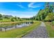 Community pond with walking path and fountain at 1099 Heyward Way, Alpharetta, GA 30009
