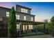 Charming two-story home featuring a covered patio and beautifully landscaped backyard at twilight at 1099 Heyward Way, Alpharetta, GA 30009