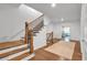 Elegant staircase with wood steps, iron railings, and a landing that leads to the bedrooms at 1099 Heyward Way, Alpharetta, GA 30009