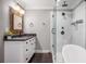 Contemporary bathroom features a glass shower, soaking tub, and vanity with storage at 1375 Miller Reed Se Ave, Atlanta, GA 30315