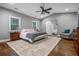 Sunlit main bedroom features hardwood floors, a ceiling fan, and an ensuite bathroom at 1375 Miller Reed Se Ave, Atlanta, GA 30315