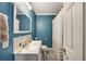 Well-lit bathroom with a gray patterned floor, blue walls, and modern fixtures at 1770 Rockland Se Dr, Atlanta, GA 30316