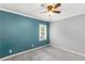 Empty bedroom with a teal accent wall, neutral paint, and a window view at 1770 Rockland Se Dr, Atlanta, GA 30316
