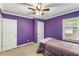 Bedroom with purple walls, carpet floors, and a cozy twin-sized bed at 1770 Rockland Se Dr, Atlanta, GA 30316