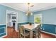Cozy dining space with an open view of the kitchen, illuminated by a modern lighting fixture at 1770 Rockland Se Dr, Atlanta, GA 30316