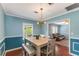 Dining room with modern lighting fixture and an open view into the living room at 1770 Rockland Se Dr, Atlanta, GA 30316