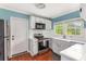 Cozy kitchen featuring white cabinets, stainless steel appliances, and a garden window at 1770 Rockland Se Dr, Atlanta, GA 30316